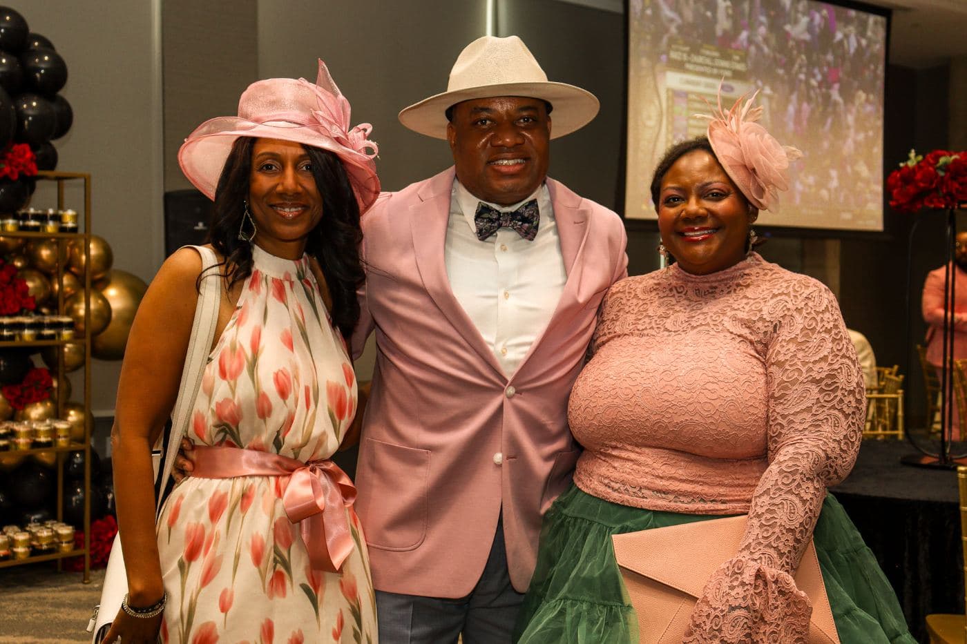 A couple in a wide-brim hat and pink jacket