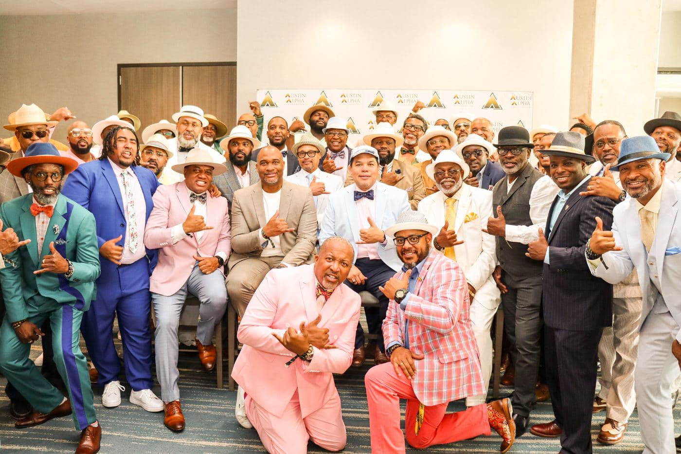 A large group of men in pastel Derby suits and hats