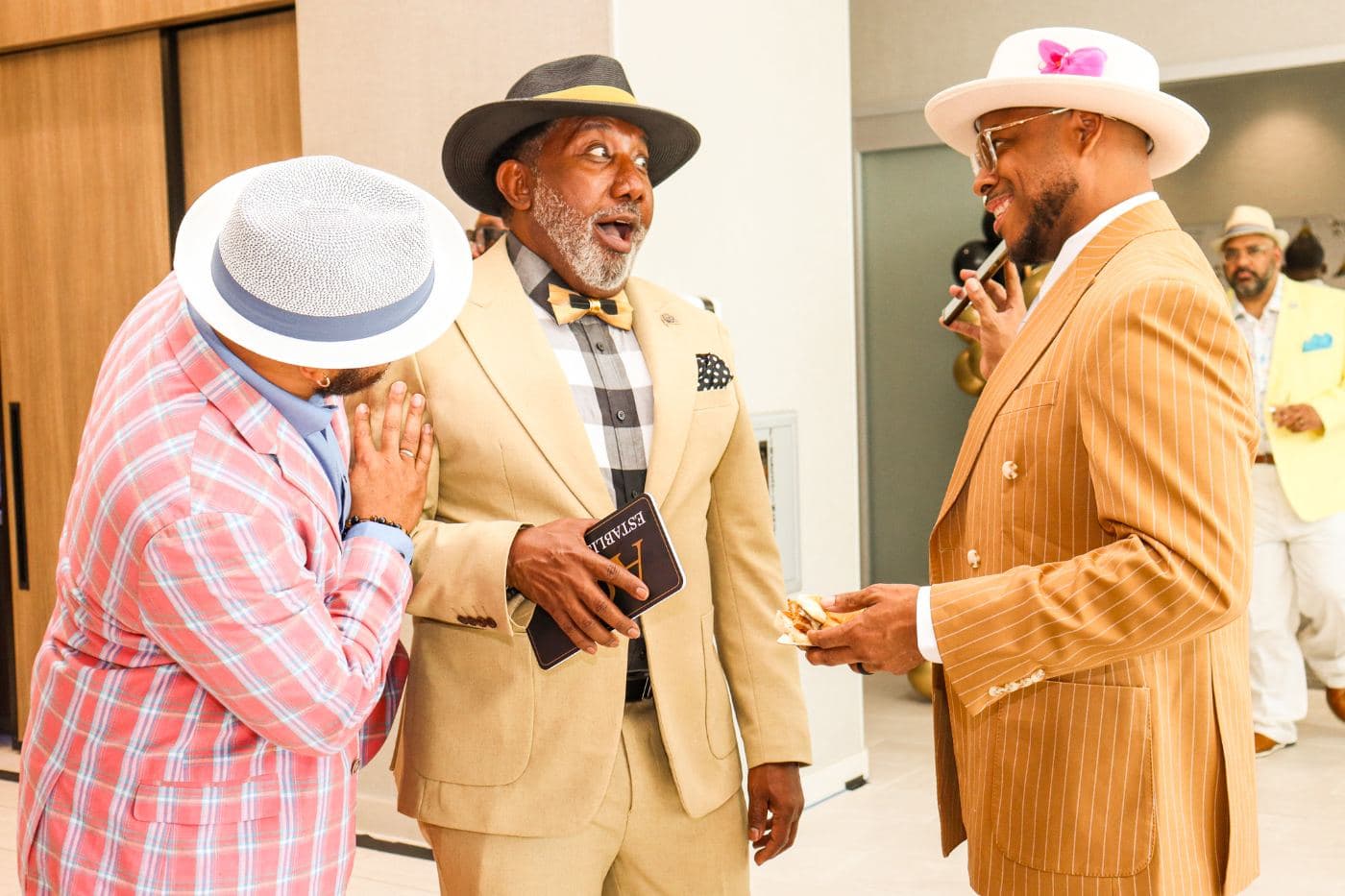 Guests in cream suits and white Derby hats