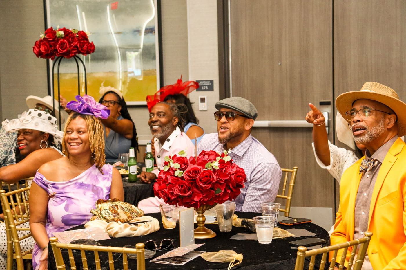 Guests at a table with red roses